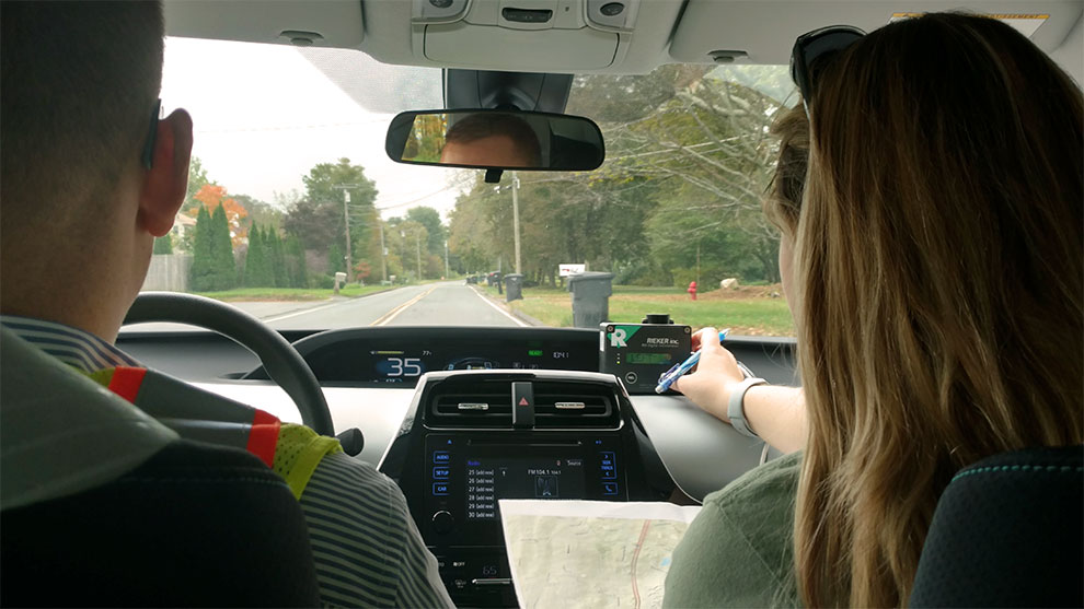 Two people in a car getting ready to survey the horizontal curves