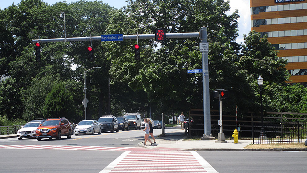 Busy intersection with people crossing the road at a crosswalk