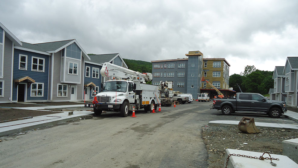 View of the renovated building, new buildings, and construction workers